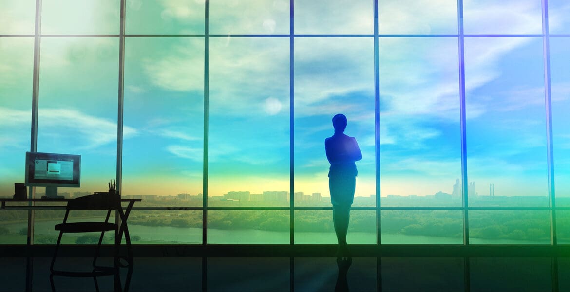 woman looking out huge windows