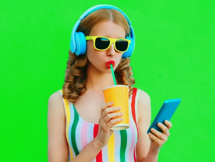 girl with headphones, glasses, phone, drink