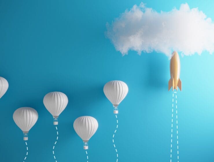 5 hot air balloons next to a rocket