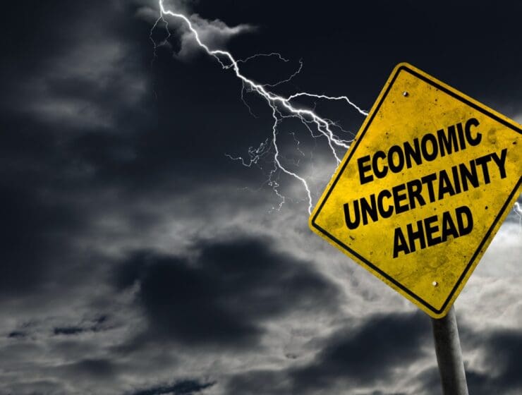 Economic Uncertainty Ahead Sign With Stormy Background stock photo